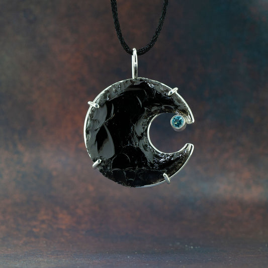 Obsidian crescent moon with aquamarine stone
